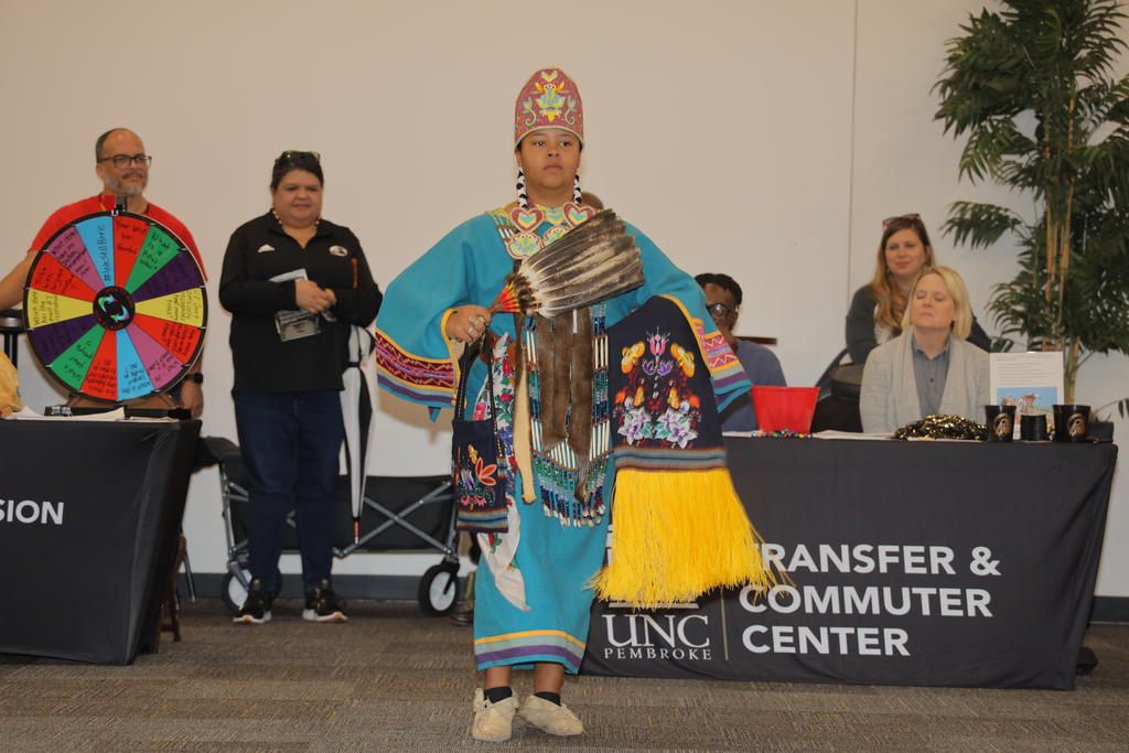 Freshman Faith Jacobs demonstrates a powwow dance during the Indigenous Peoples' Day celebration at UNCP