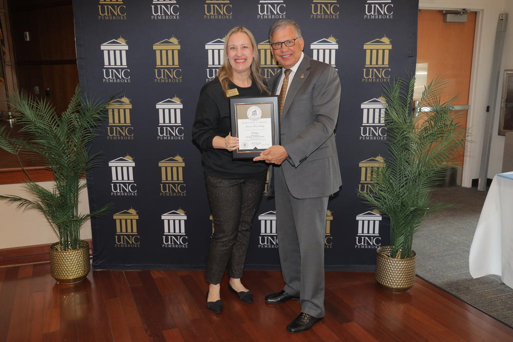 Chancellor Robin Gary Cummings presents Dr. Joanna Hersey with an award recognizing her 15 years of service