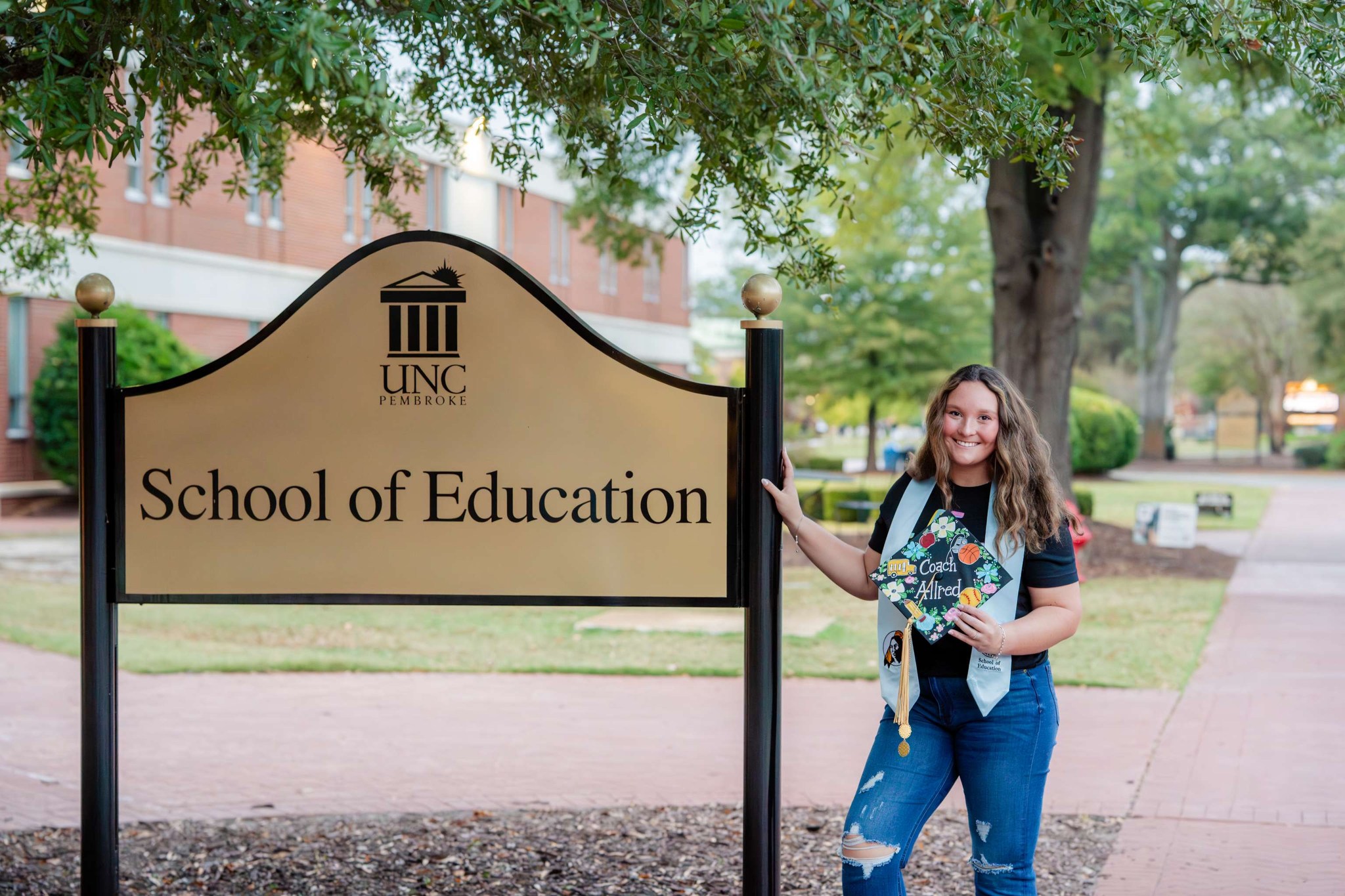 student in front of UNCP School of Education