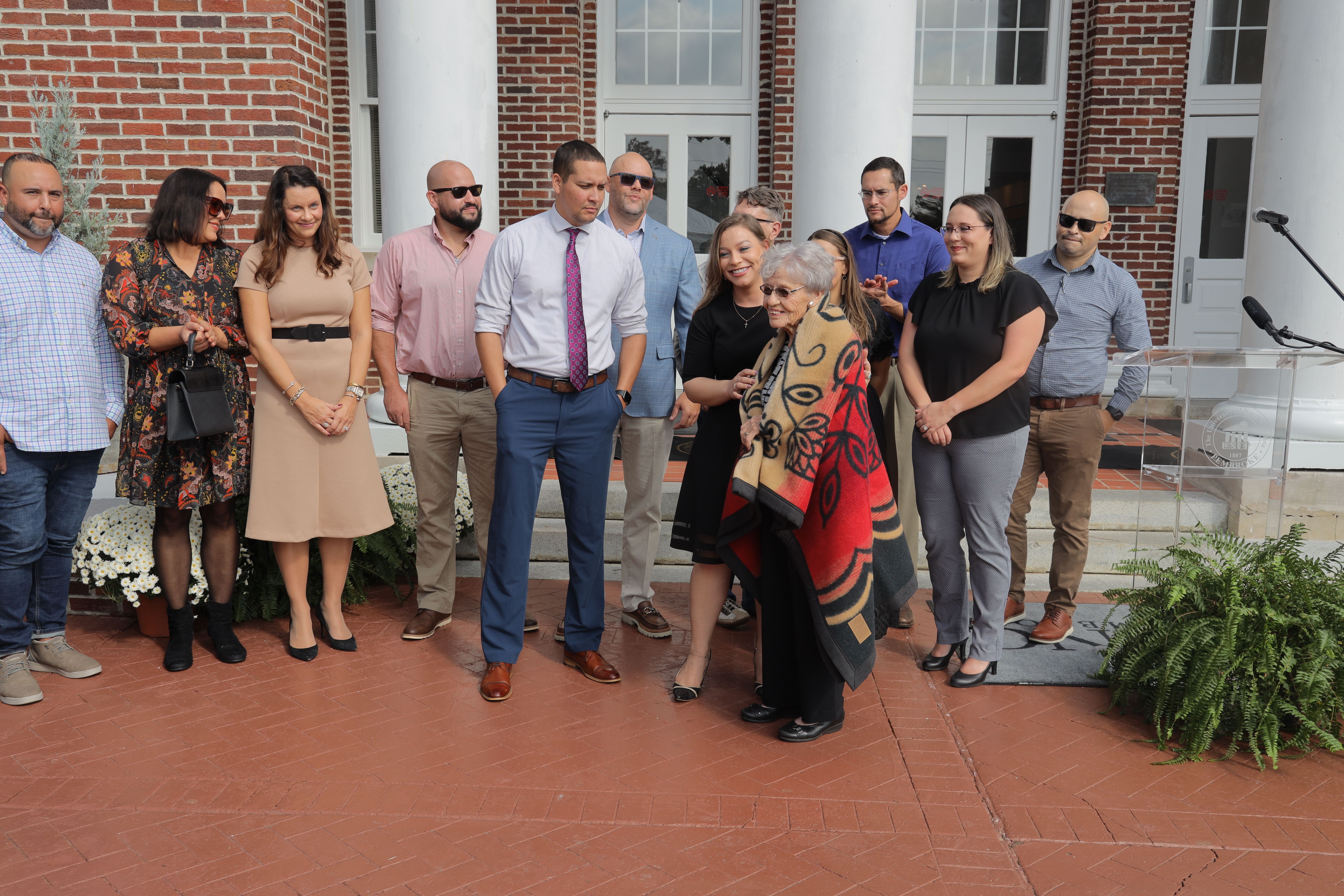 The family of Curt and Catherine Locklear cut the ribbon on the American Indian Heritage Center at UNCP during a ceremony on Tuesday, November 1.