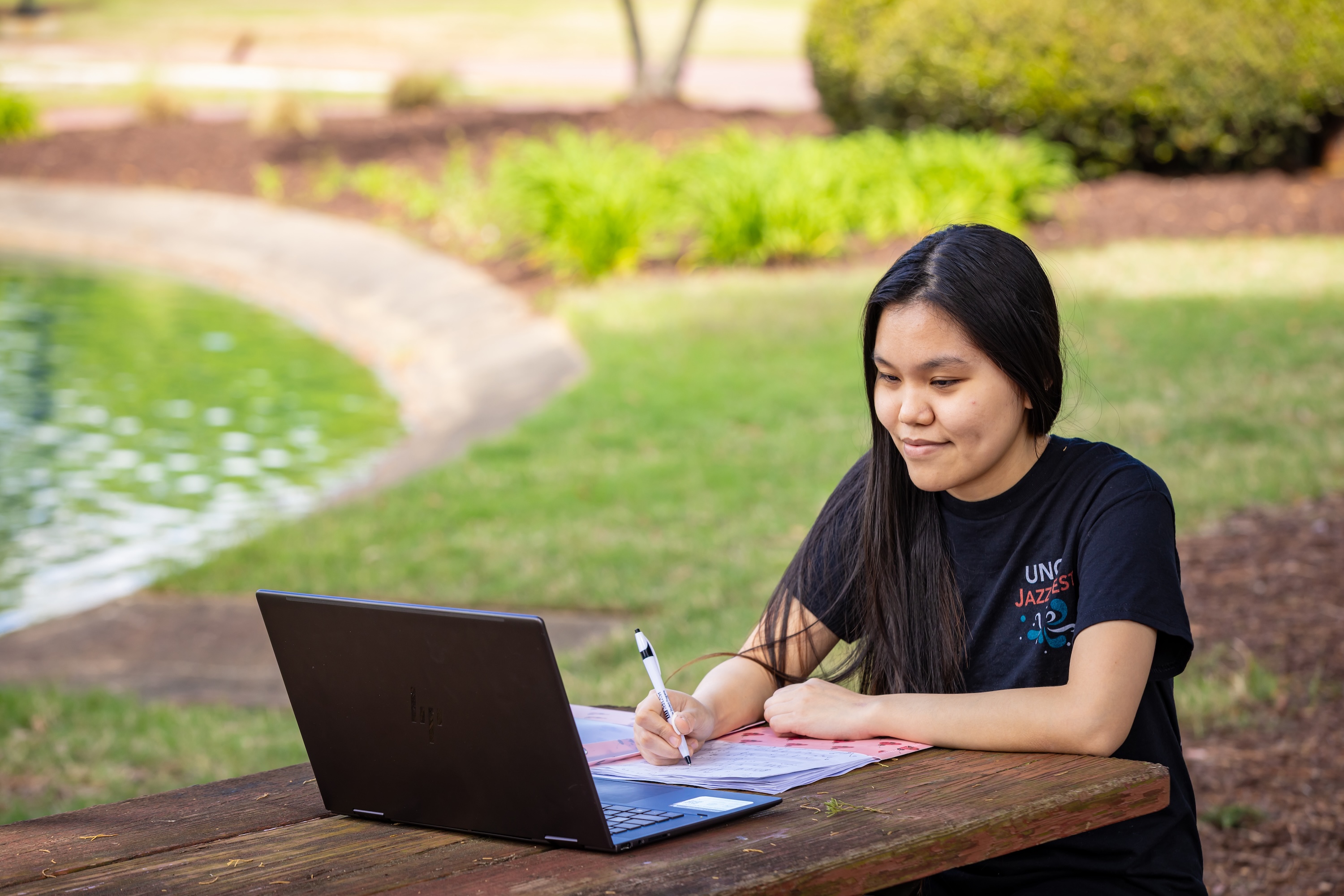 Asian Student on Campus UNCP near pond