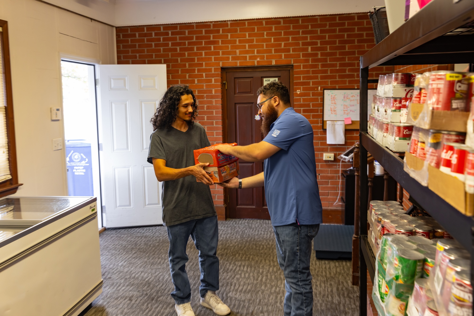 UNCP student giving Ramen to the Braves Resource Center