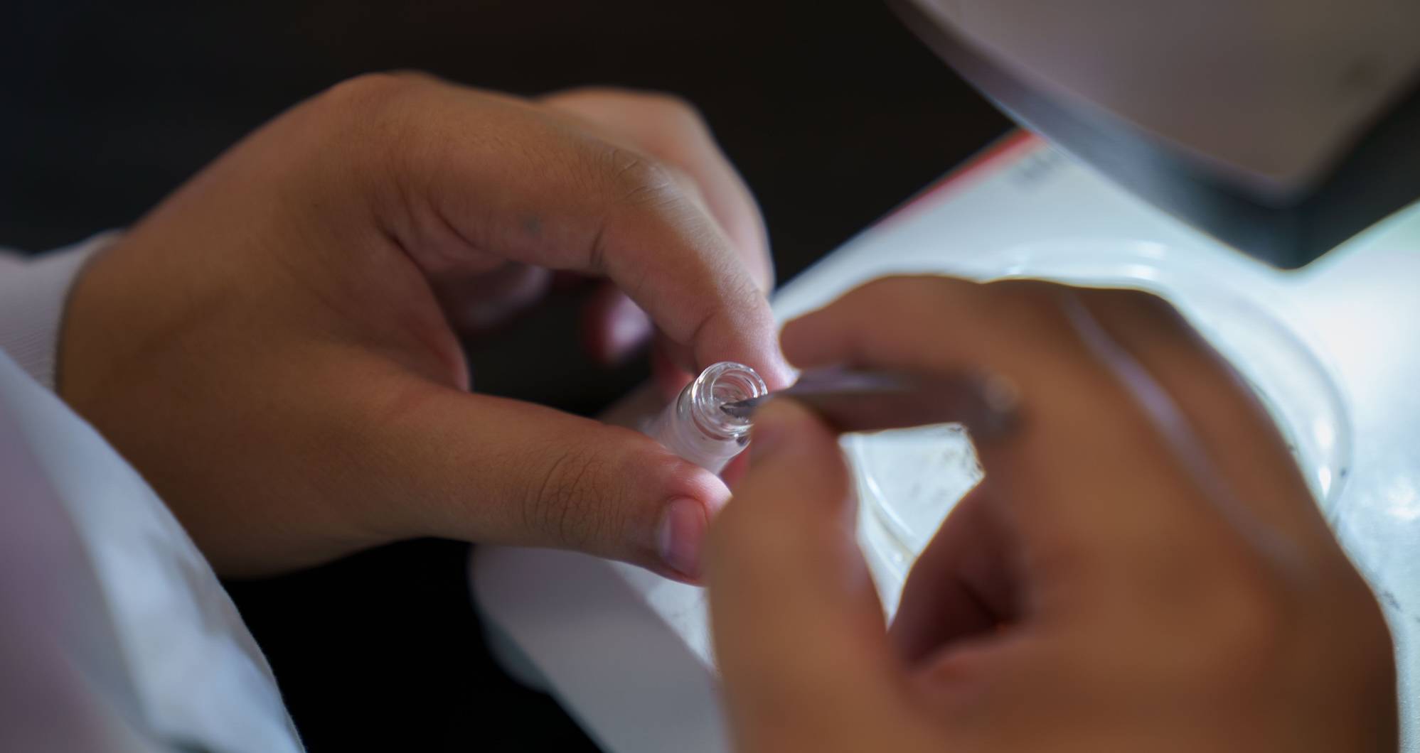 UNCP student holding a biology glass
