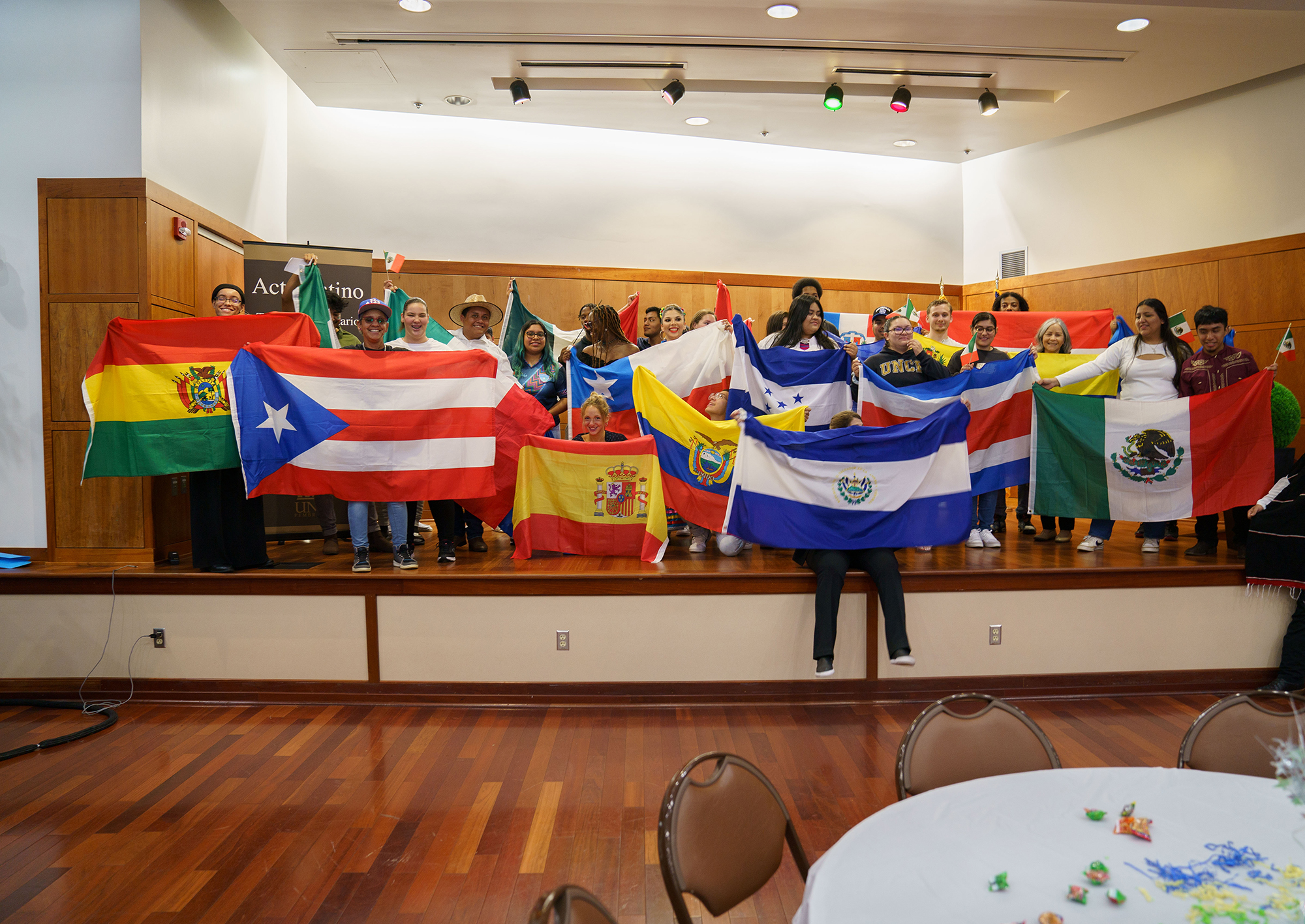 students at UNCP holding up Hispanic flags