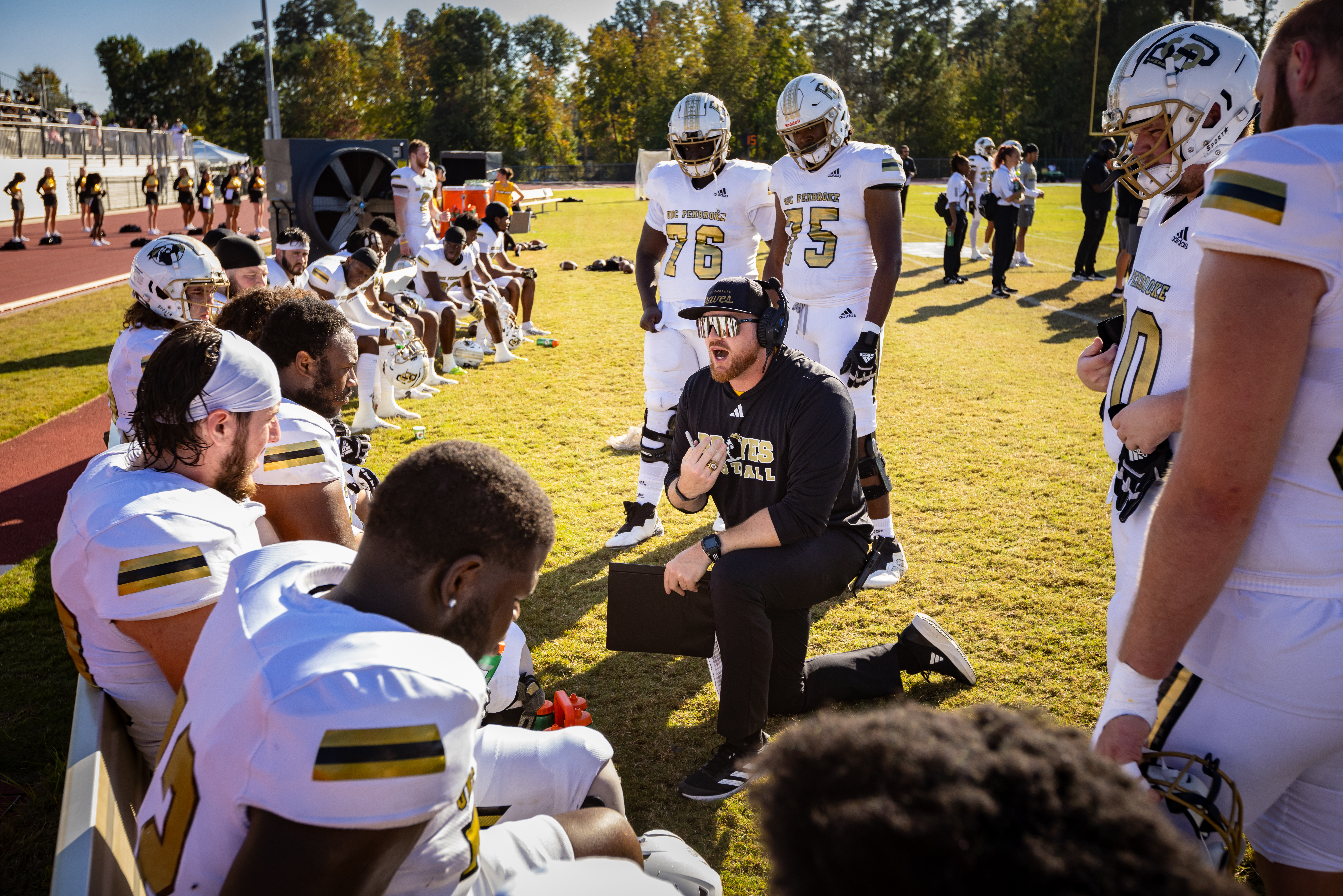 UNCP football coach talking with the team