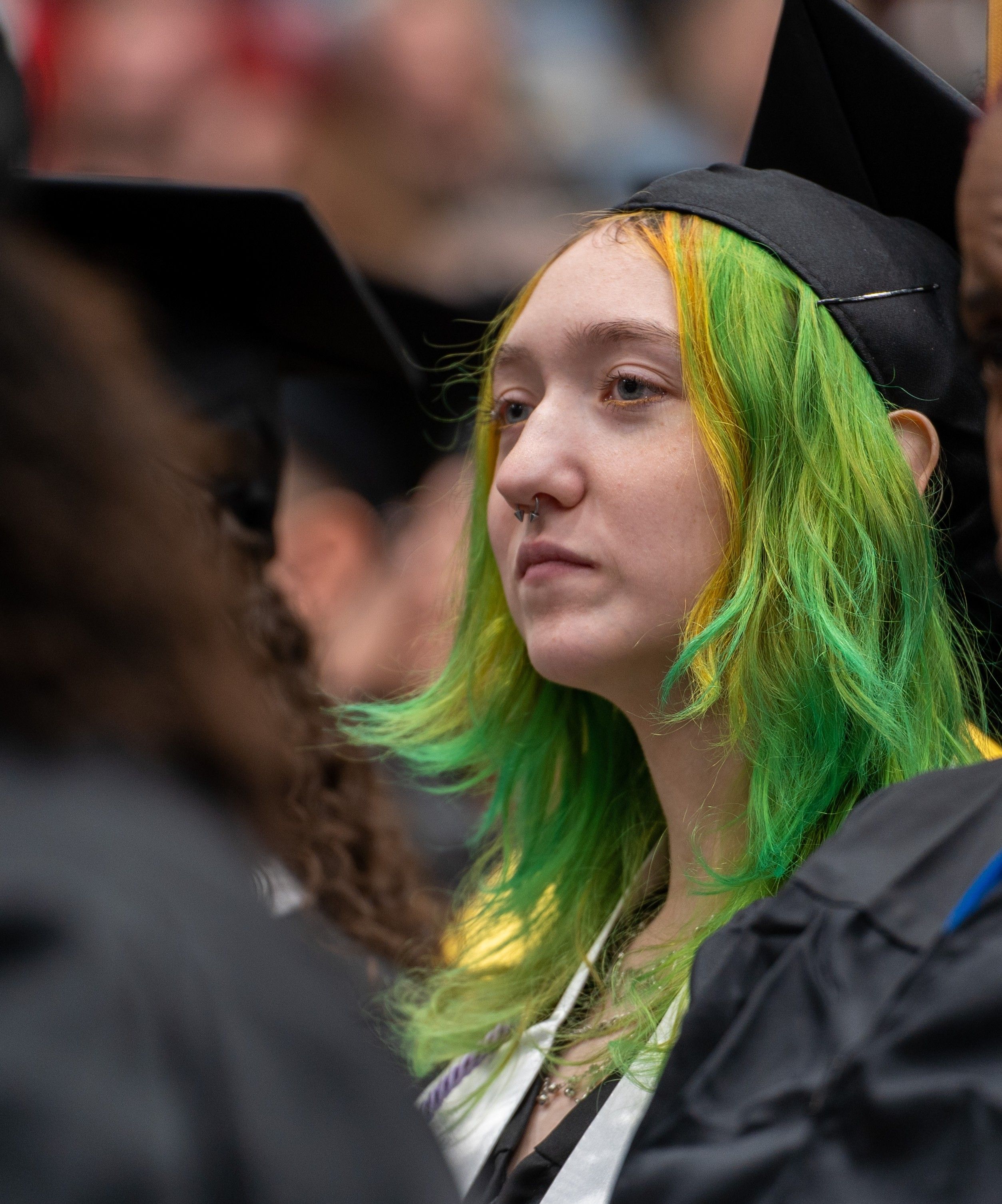 Art student in her cap an gown at winter commencement.