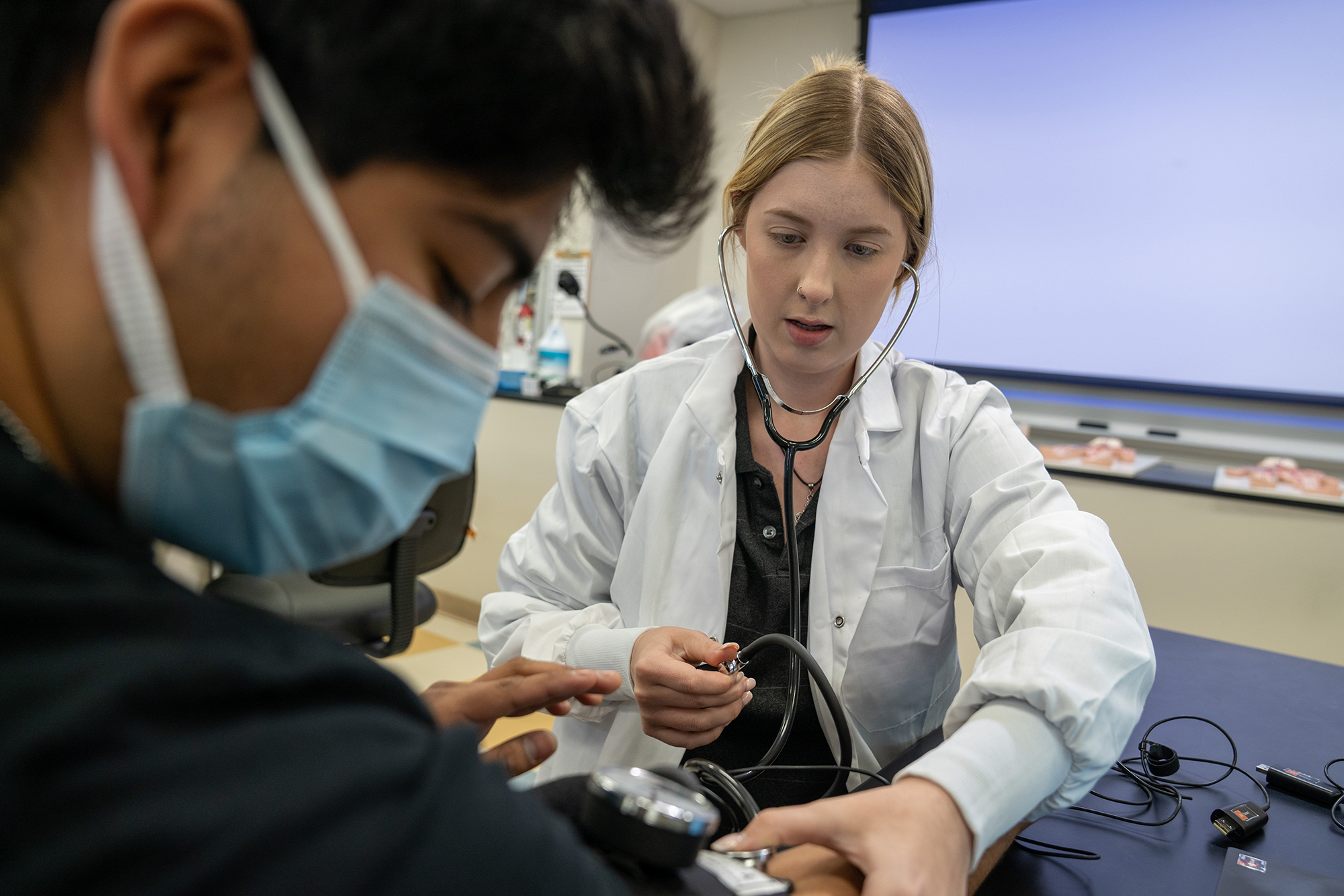 student in biology class checking heart rate