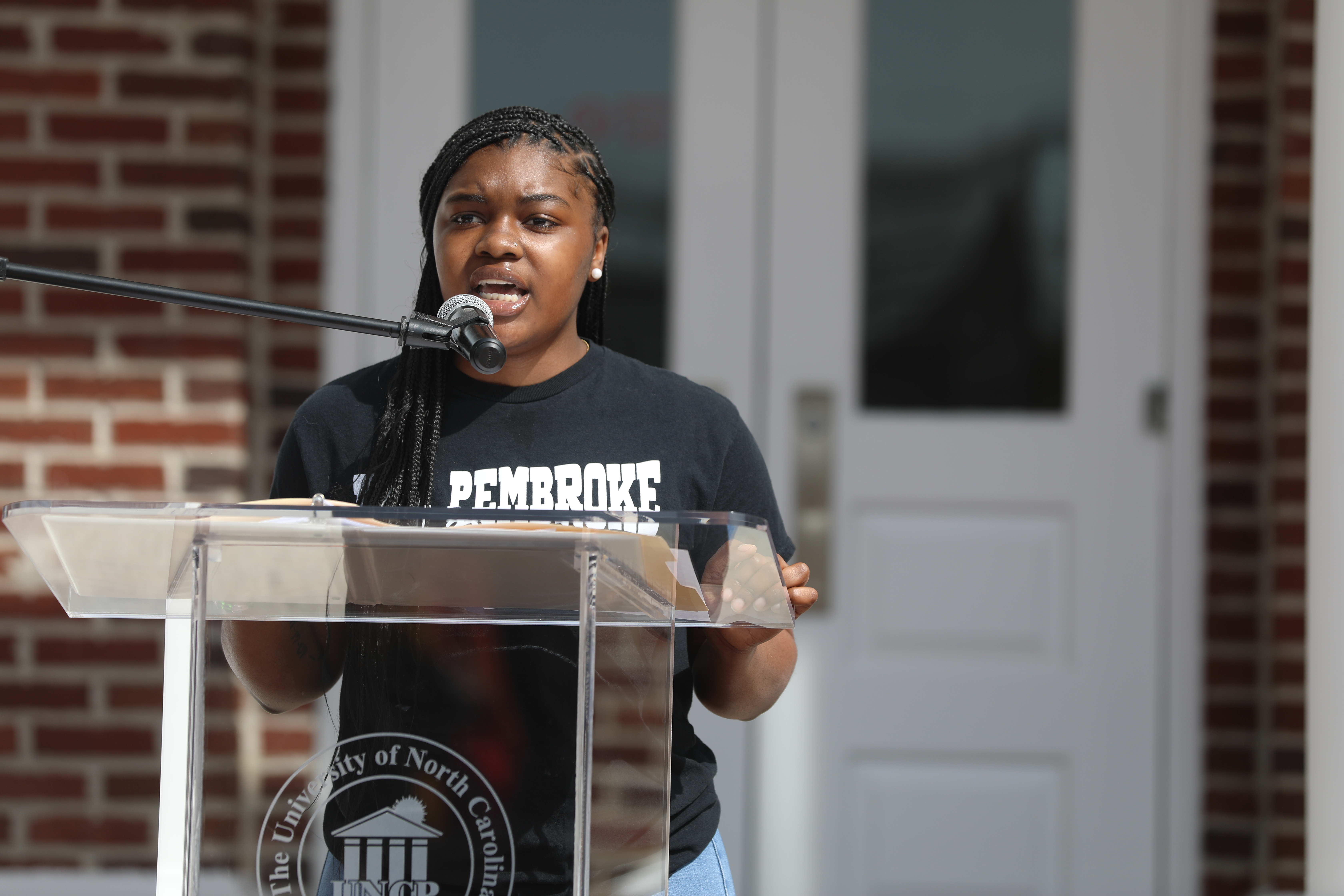 Taliyah Daniels speaks at a ceremony on the UNCP campus.