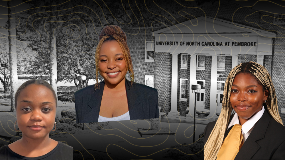 three students with Old Main in the background