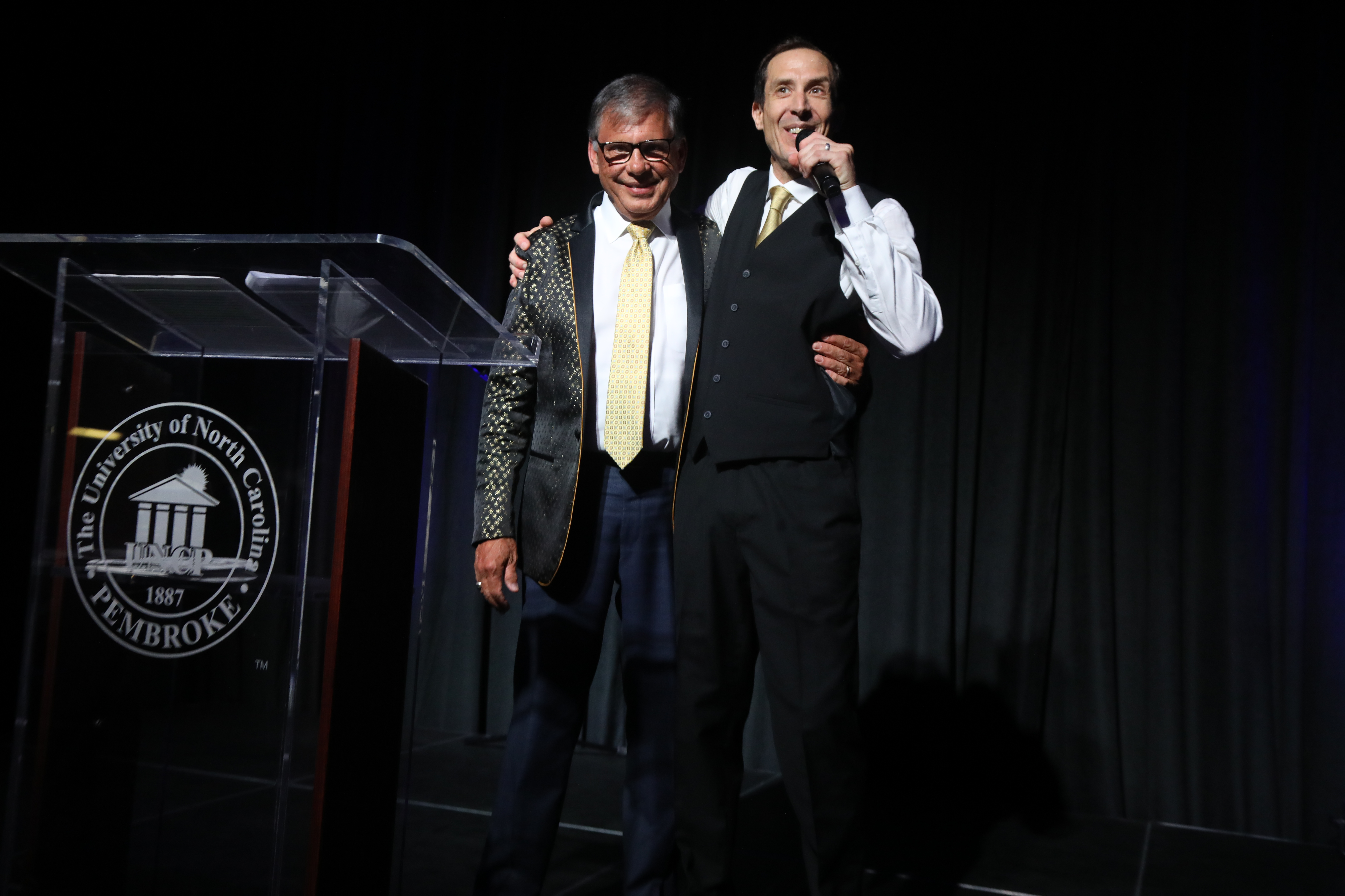 Chancellor Robin G. Cummings and auctioneer Brian Calabria