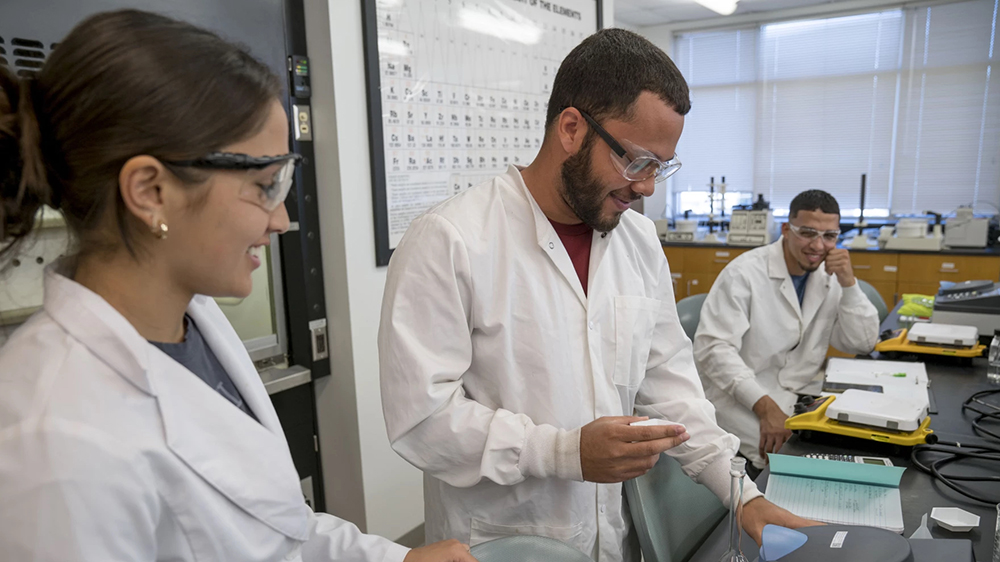 Students at UNC-Pembroke work with chemistry lab equipment.