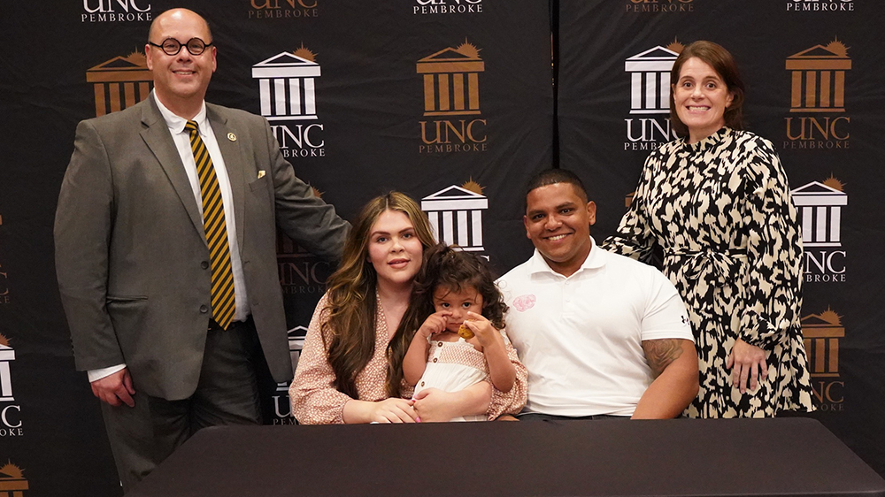 Taley Hunt, her husband, Jordan, and their daughter, Reese, is joined at the gift signing ceremony with Dr. Jeff Howard, vice chancellor for Student Affairs, and Dr. Christie Poteet, associate dean of Students