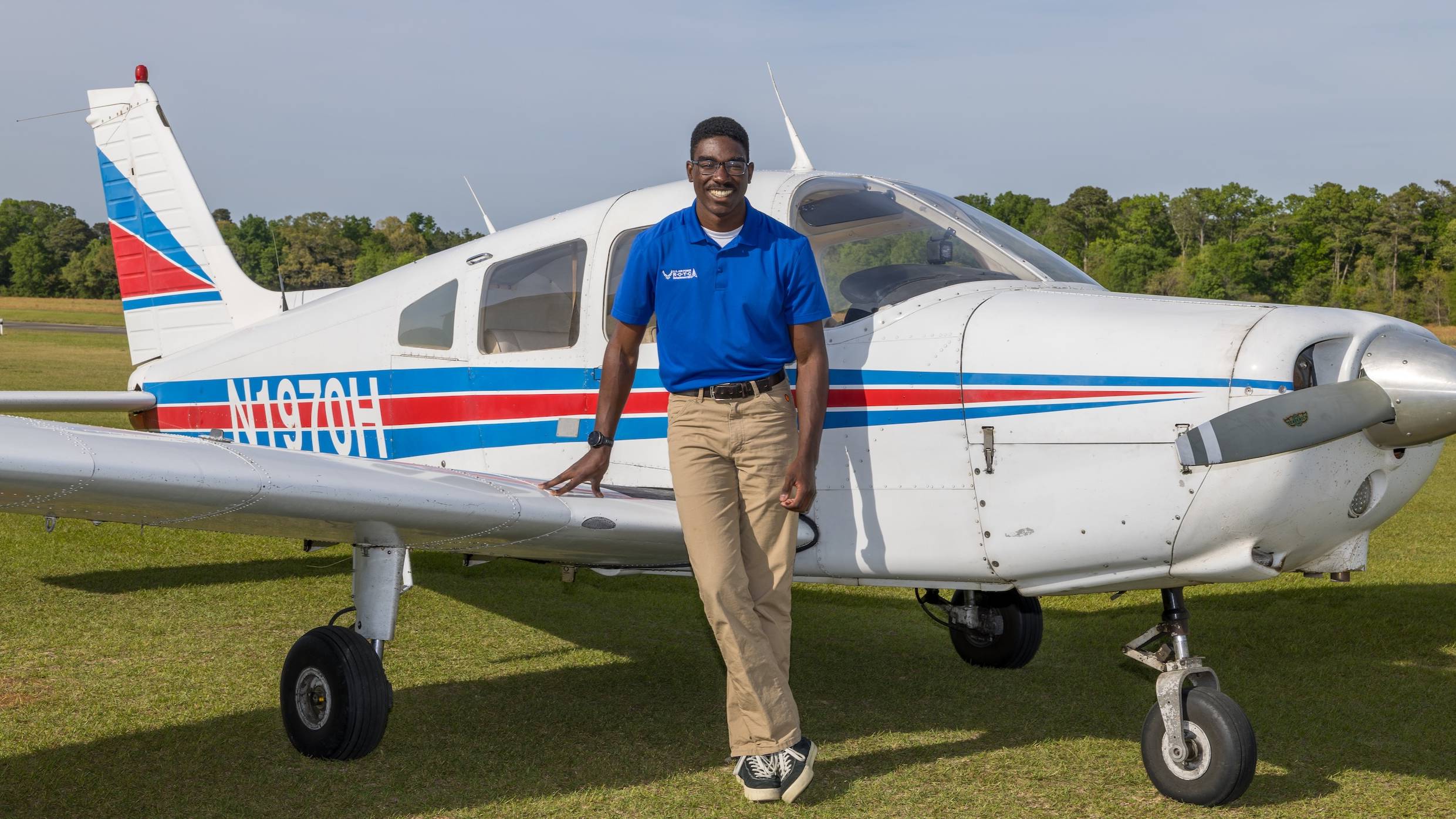 UNCP Air Force ROTC Cadet Maximus Lang stands in front of a Piper PA-28-161 Warrior II at Fayetteville Regional Airport.