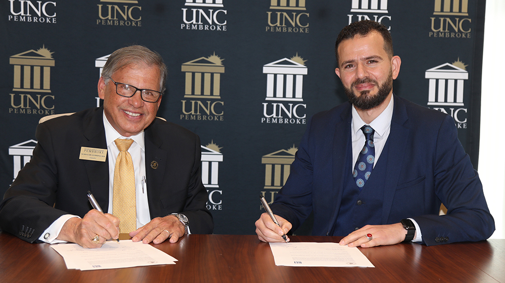 UNCP Chancellor Robin Gary Cummings (left) and Dr. Oussama Ammar, dean of programs at Montpellier Business School, establish an academic partnership during a MOU signing event at UNC Pembroke.