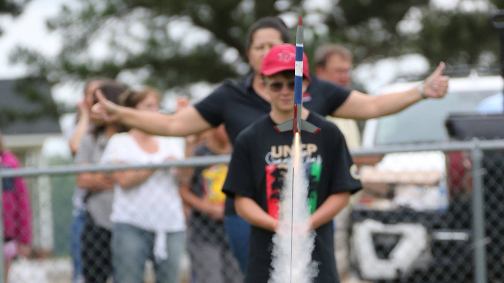 A youth camper launches an A8-3 model rocket during the Cummings Aerospace Engineering Camp at UNC Pembroke on June 23, 2023 