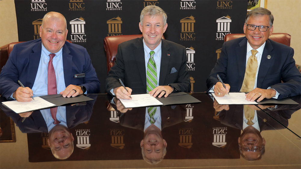 Moore County Schools Superintendent Tim Locklair, left, Sandhills Community College President Sandy Stewart and UNCP Chancellor Robin Gary Cummings