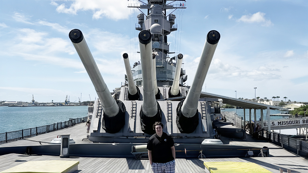Mason Schweneker stands on the deck of the USS Missouri in Pearl Harbor