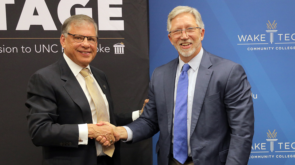 UNCP Chancellor Robin Gary Cummings and Wake Tech President Dr. Scott Ralls shaking hands