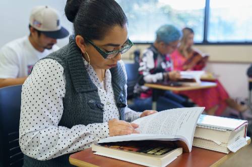 uncp student looking at a book