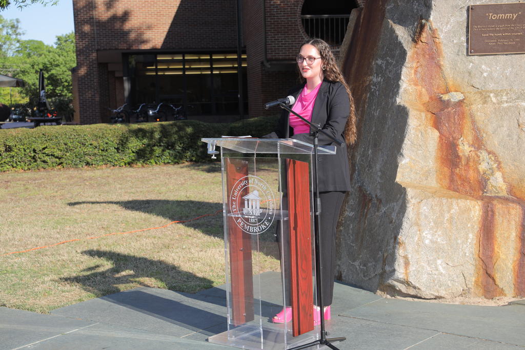 Aspen Andersson at a podium on the UNCP campus.