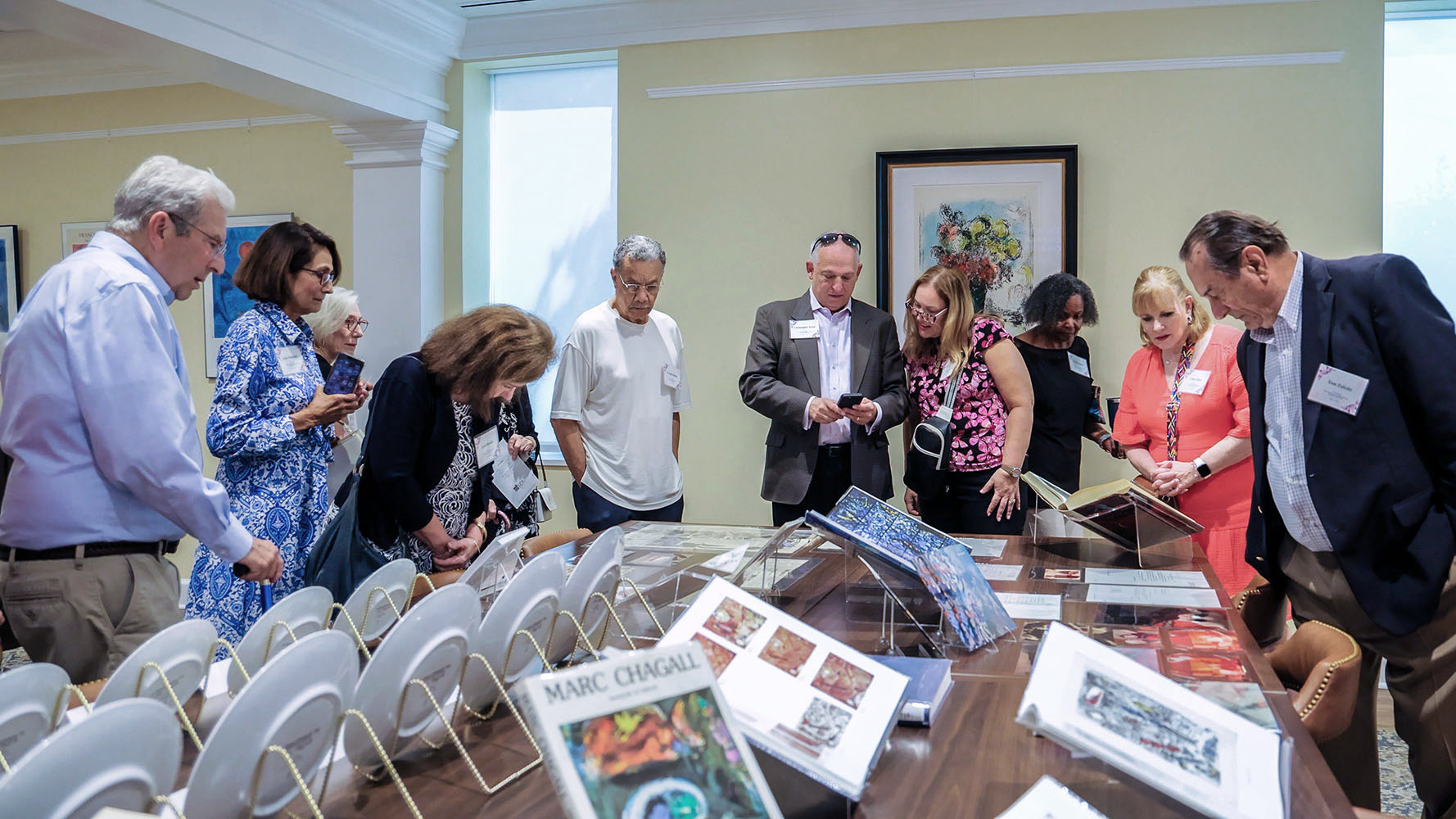 Visitors view artwork and other materials at the opening of the Vivian R. and Ralph Jacobson Special Collections room at UNCP.