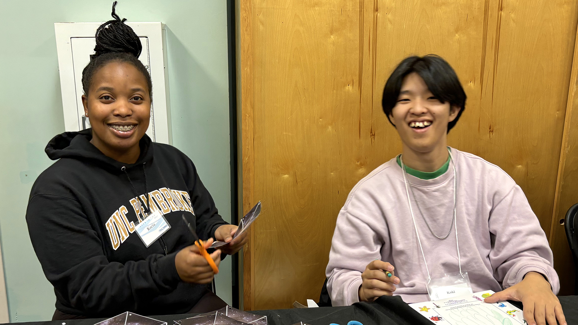 College students staff booth exhibits