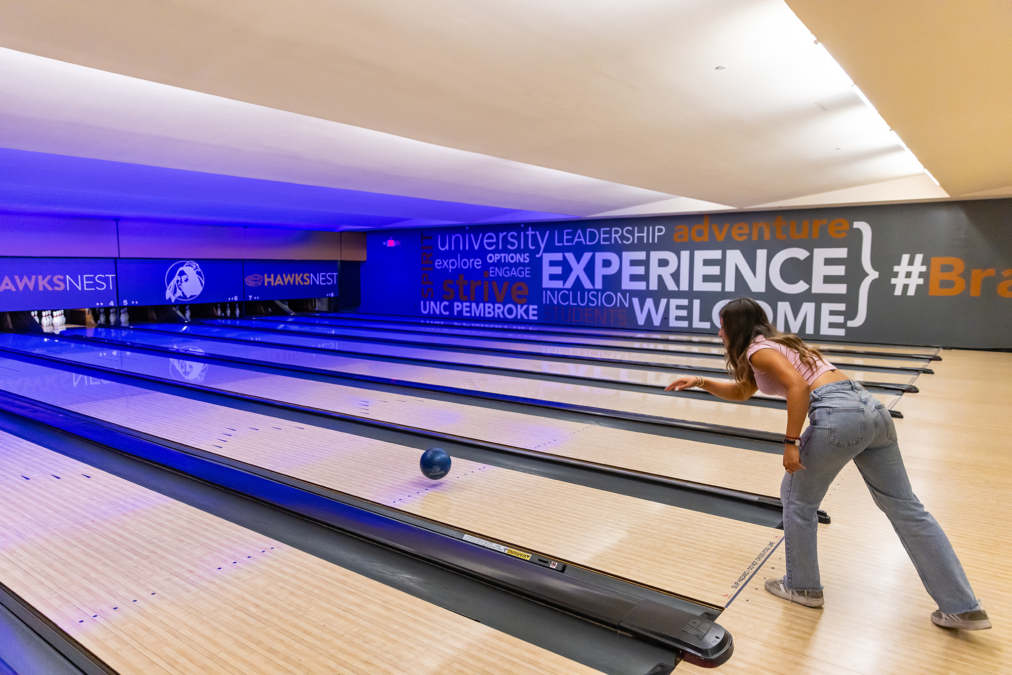 female student bowling at UNC Pembroke