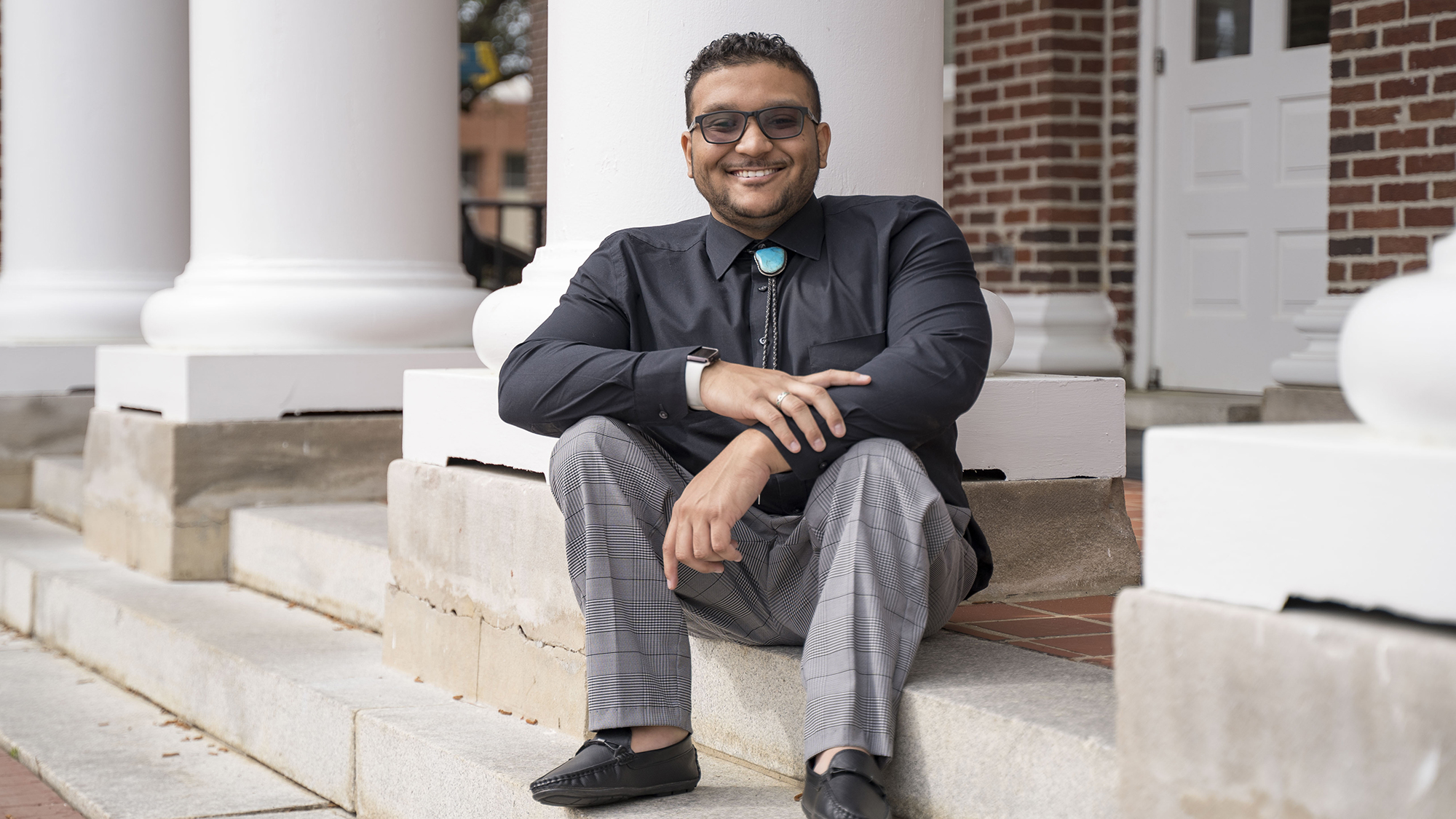 Benjamin sitting on the steps of Old Main