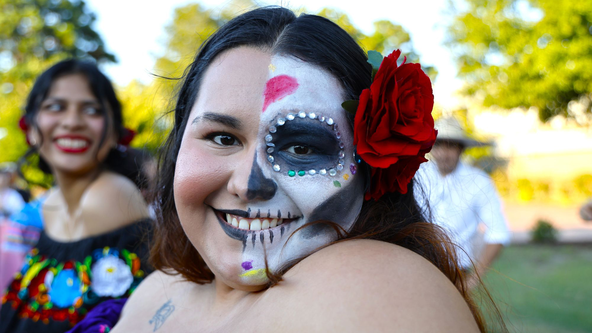A UNCP student wearing La Catrina face paint representing Día de los Muertos at the OGE cultural fashion show.