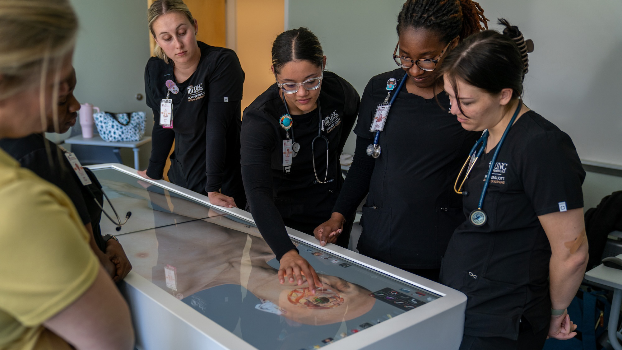 UNCP nursing students looking at the anatomy table