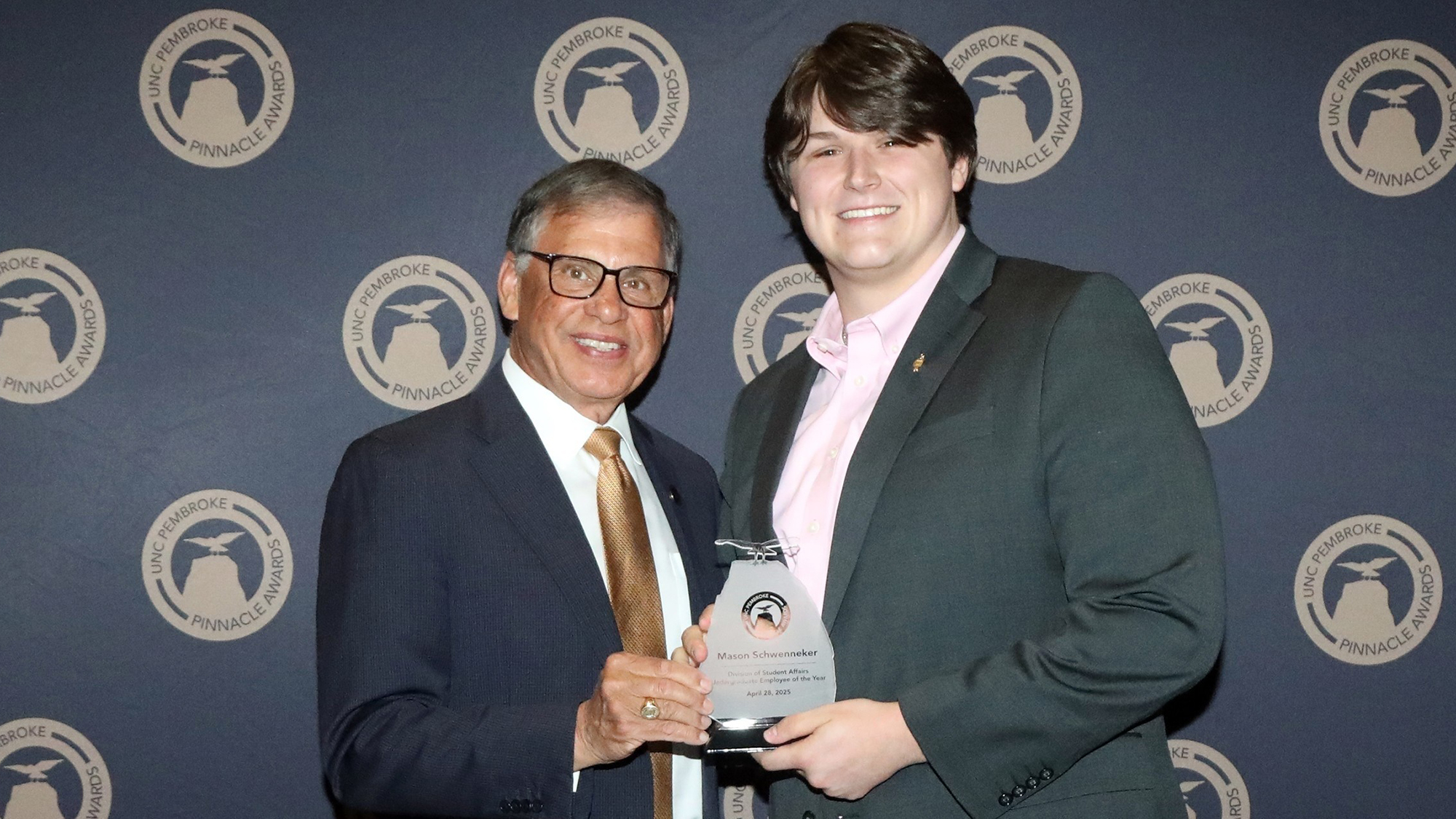 Honors student accepting an award from UNC Pembroke Chancellor Robin Cummings
