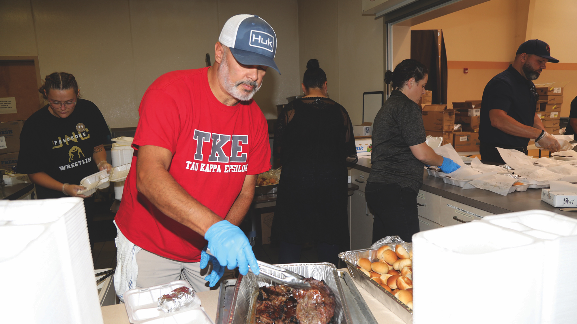 male volunteer prepares beef