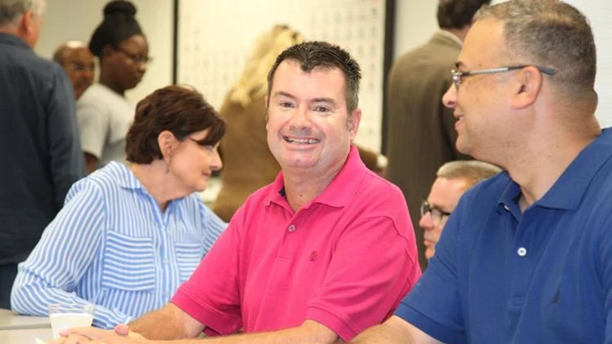 Dr. Tim Ritter sitting at a table with other faculty