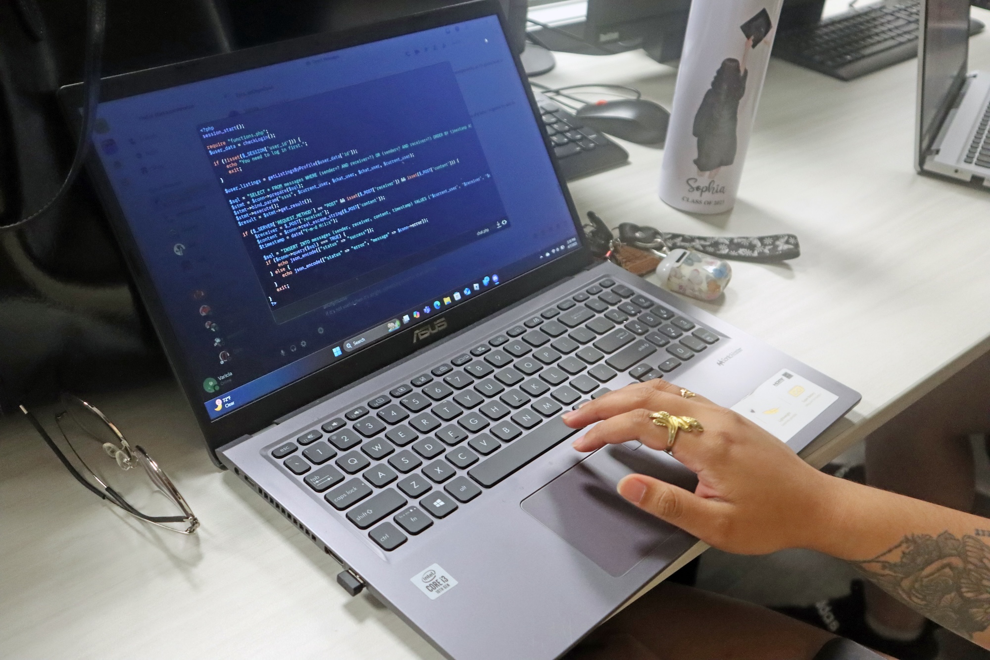 A UNCP student writes code on a laptop, representing the Computer Science with Programming minor.