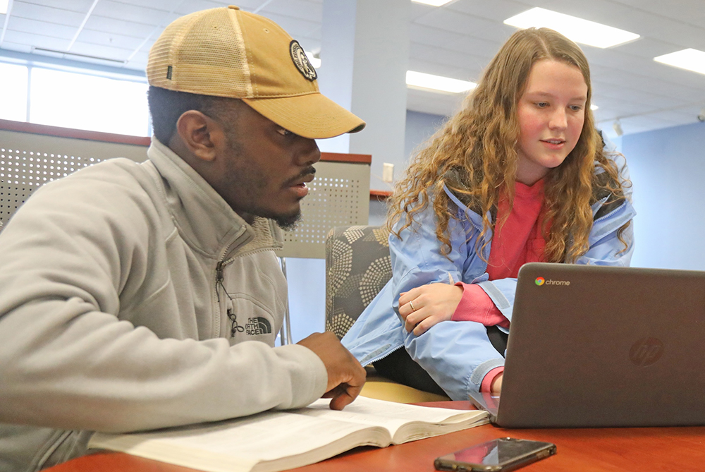 male and female student on laptop