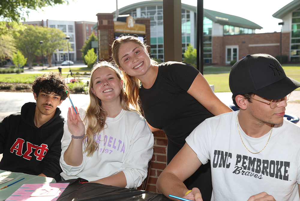 Members of Greek community painting together