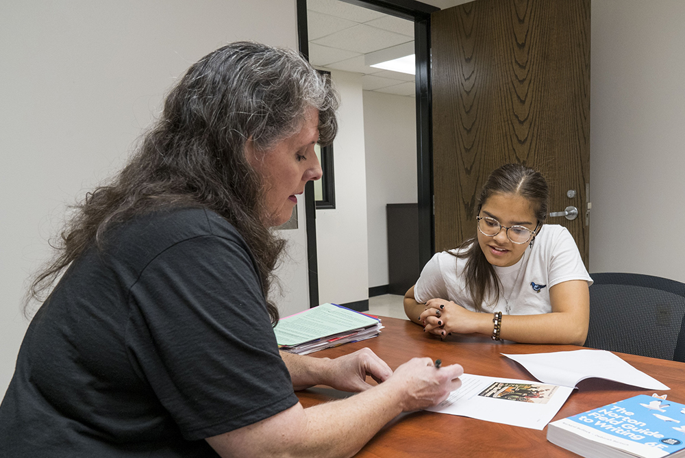 Summer Bridge teacher helping student