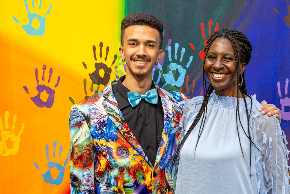 UNCP art student and his mom in front of an art display at the AD gallery