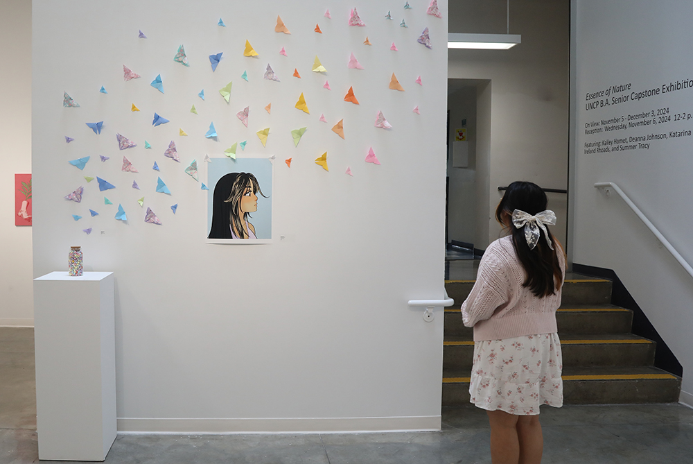 girl standing in front of an art display