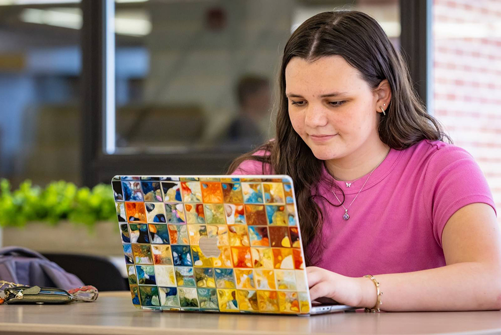 UNCP student on a Macbook
