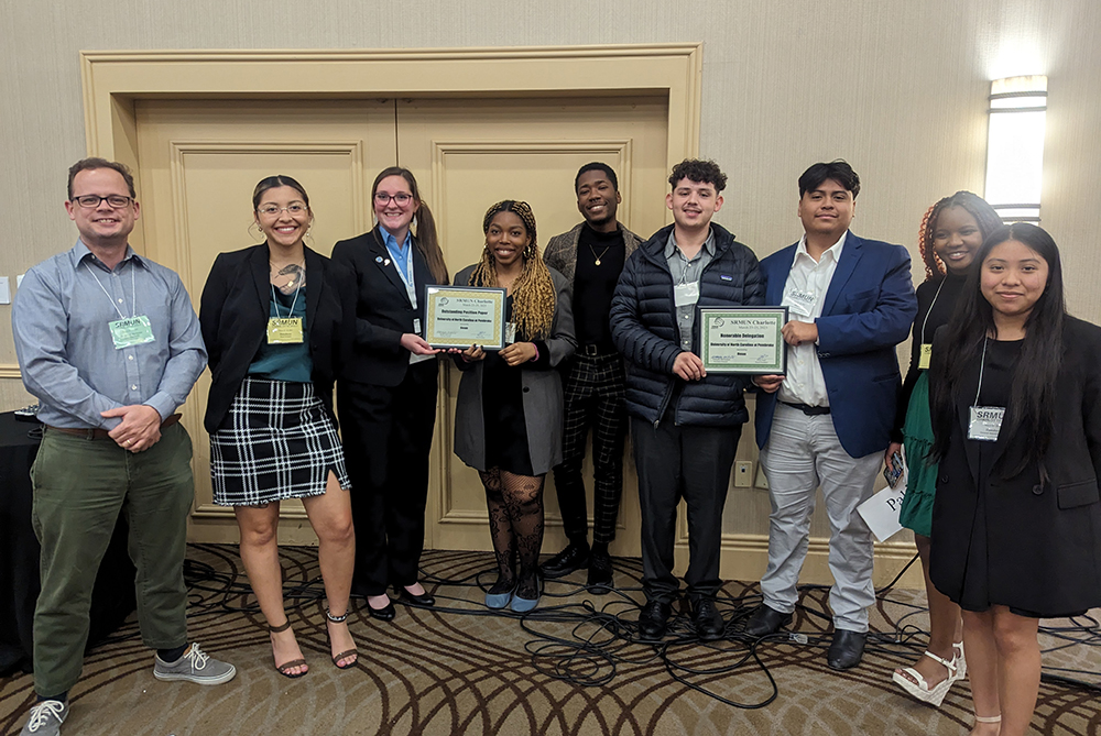 Dr. Josiah Marineau (far left), faculty advisor, is pictured with SRMUN team members Katie Aguilar Manueles, Aspen Andersson, Sharon Daminabo, Kristian Johnson , Ethan Deese, Jose Perez, Anesu Mavhiya, Magally Ortiz-Rojas