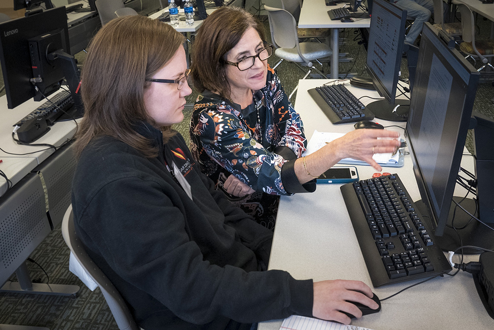 genomics education teacher with student at computer