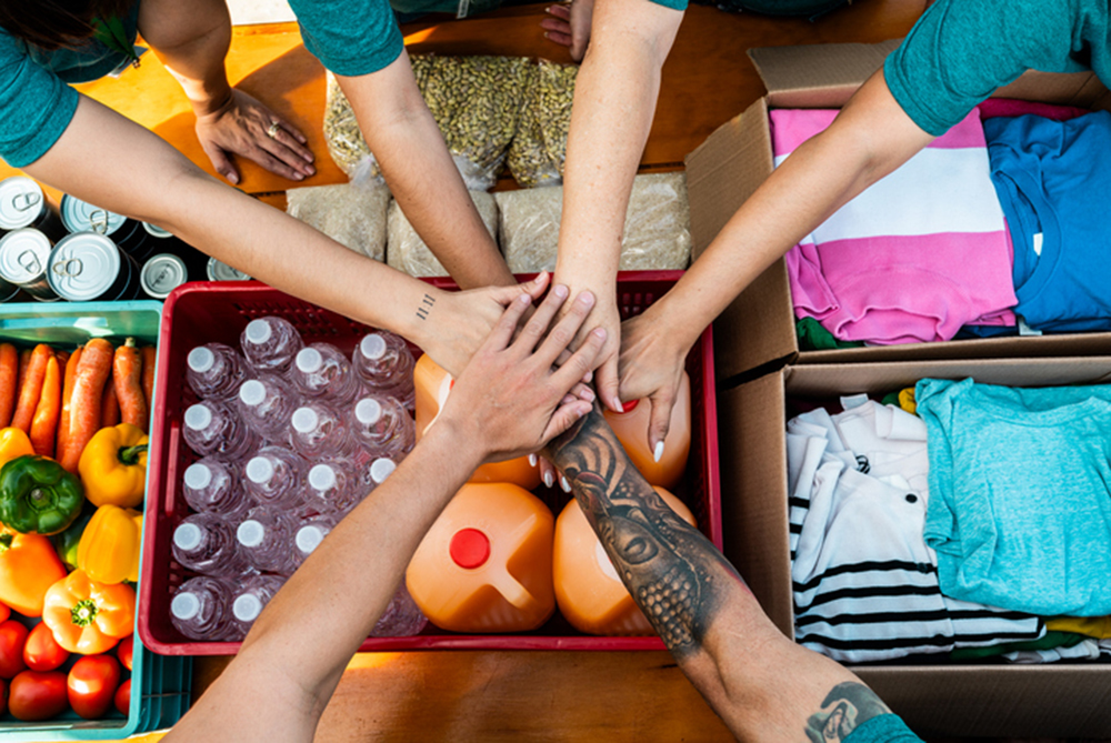 hand in a pile on top of donations