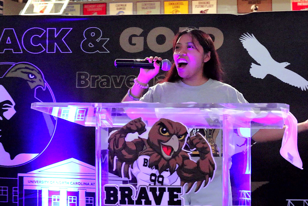 Student Government president speaking at a podium at a Welcome Week event at UNC Pembroke.