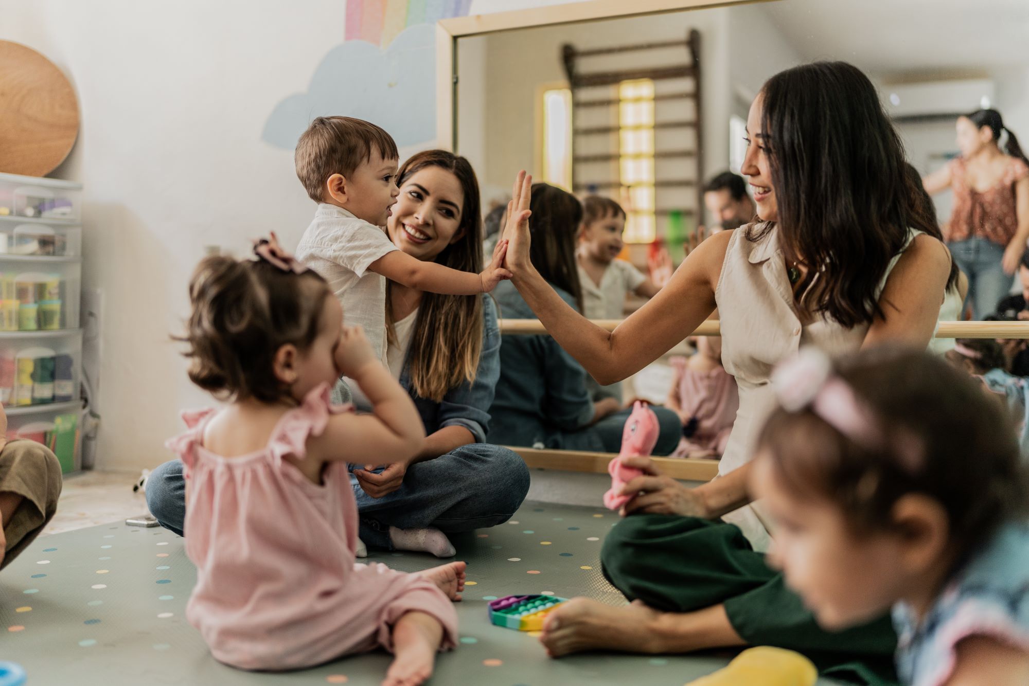 Group of women with kids in a playroom