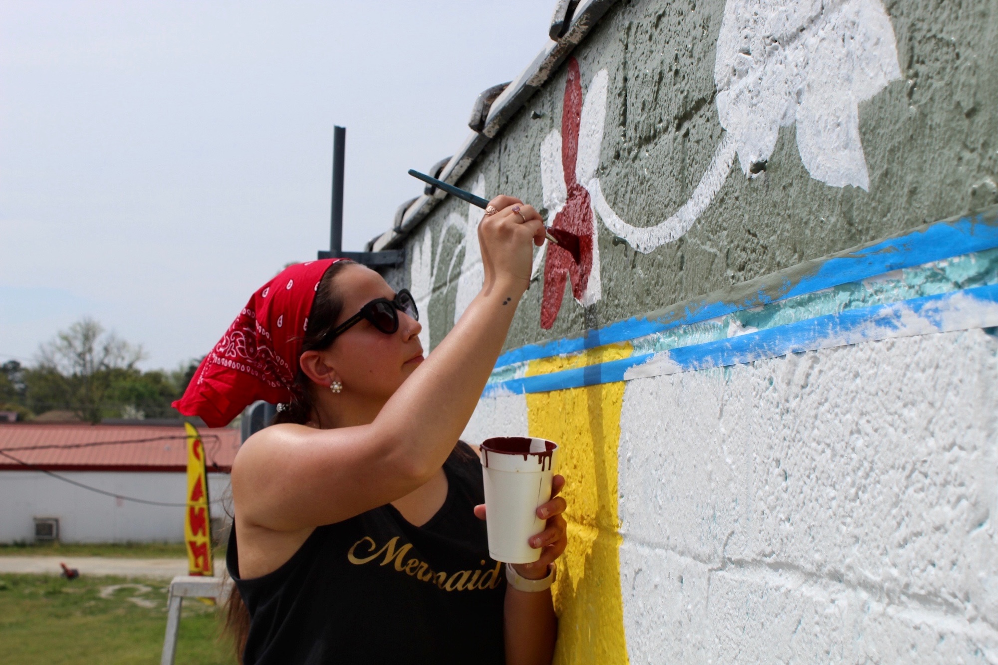 UNCP student painting a mural