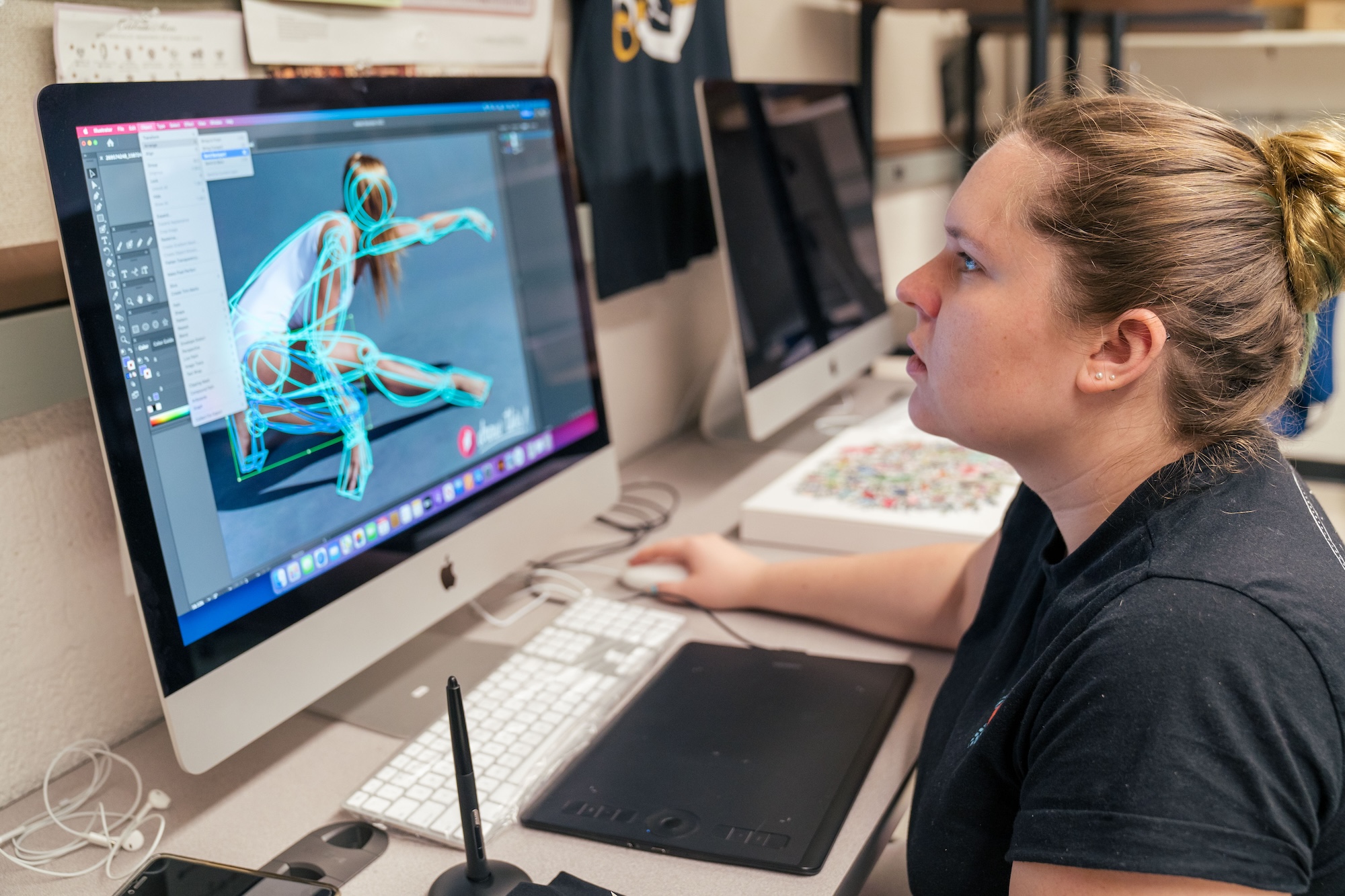 Woman on a computer with digital art on it