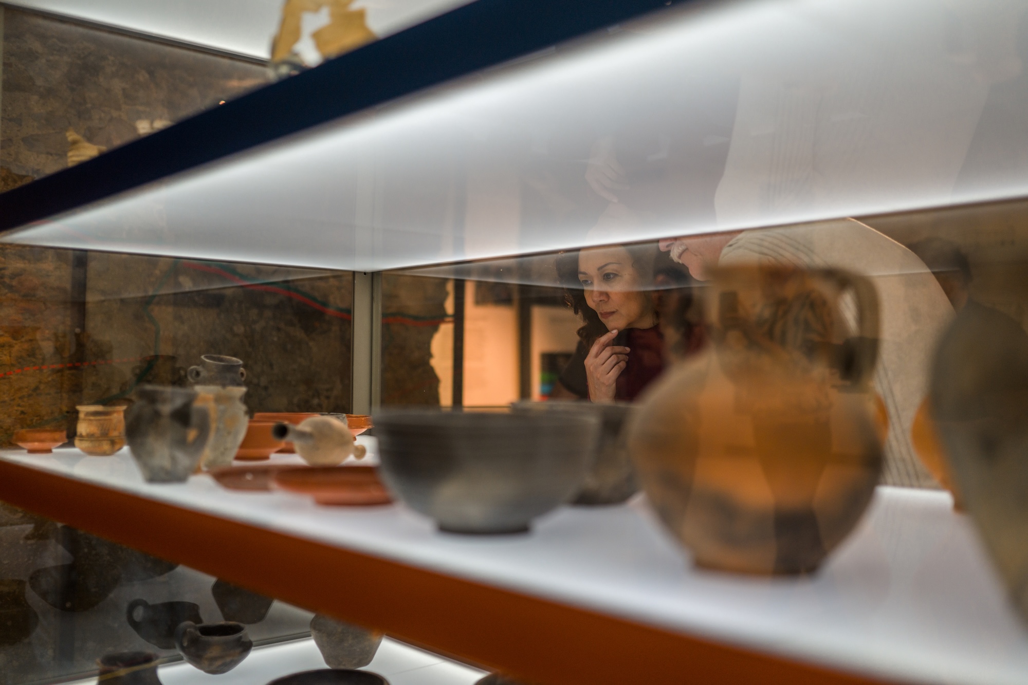 woman looking at museum items