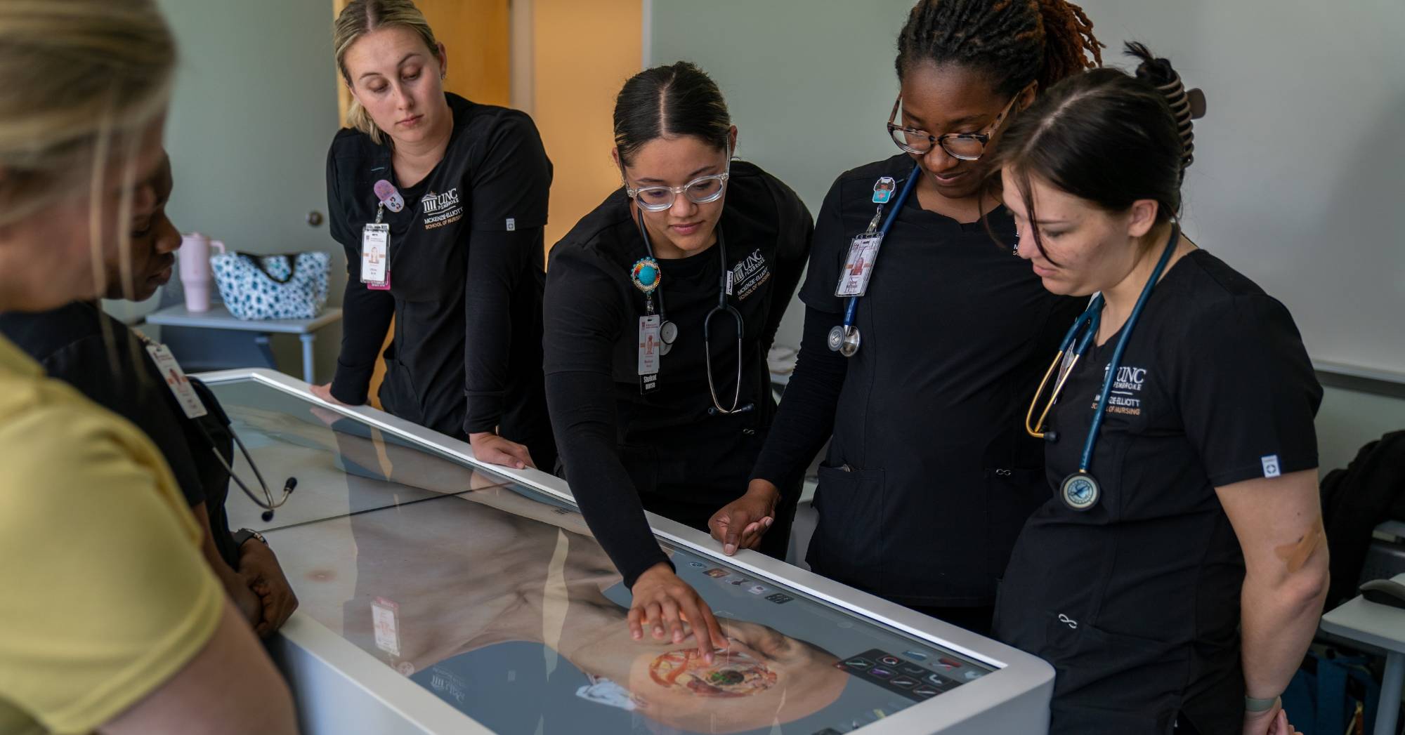 Nursing Students interacting with an anatomy simulator