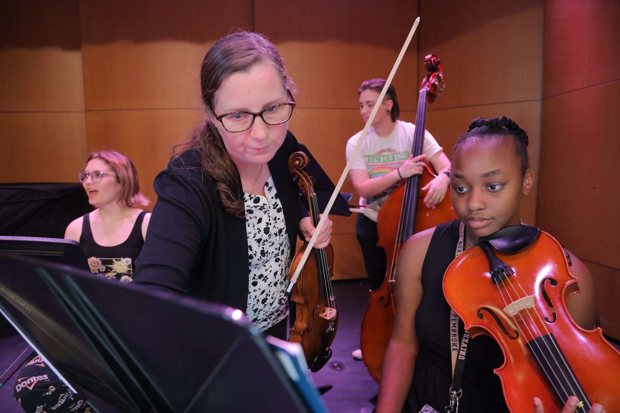 A music teacher teaching orchestra UNC Pembroke